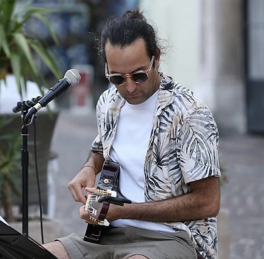 Soul Kitchen guitarist playing during a street performance